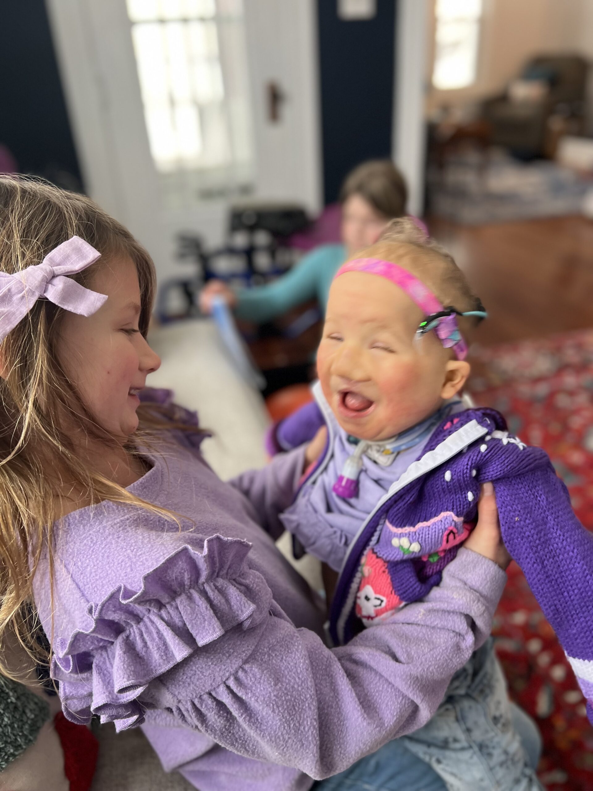Izzy with her sister, both girls smiling