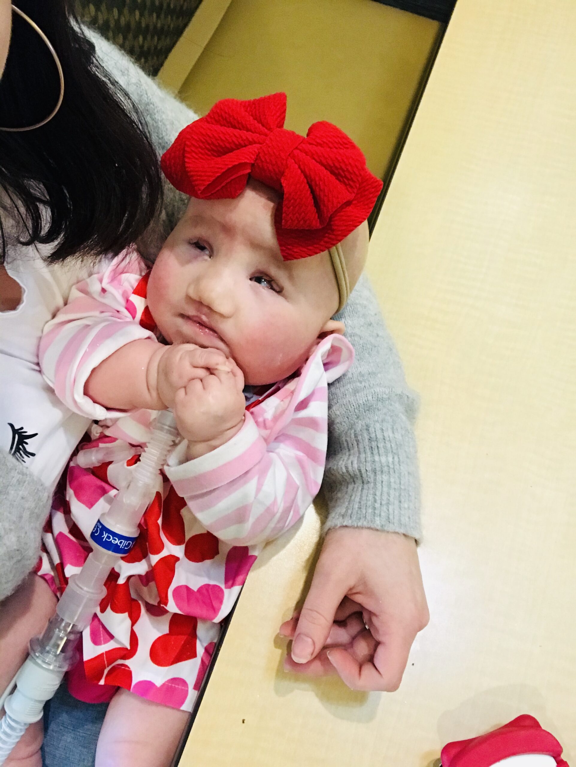 Izzy Farmer wearing a big bow, smiling