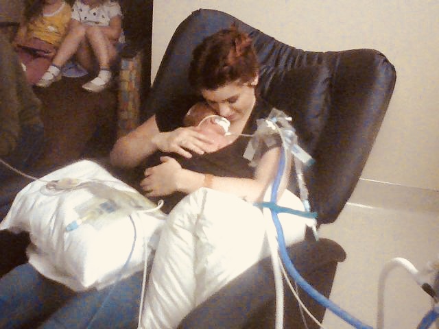 Kailey Farmer holding newborn Izzy shortly after birth