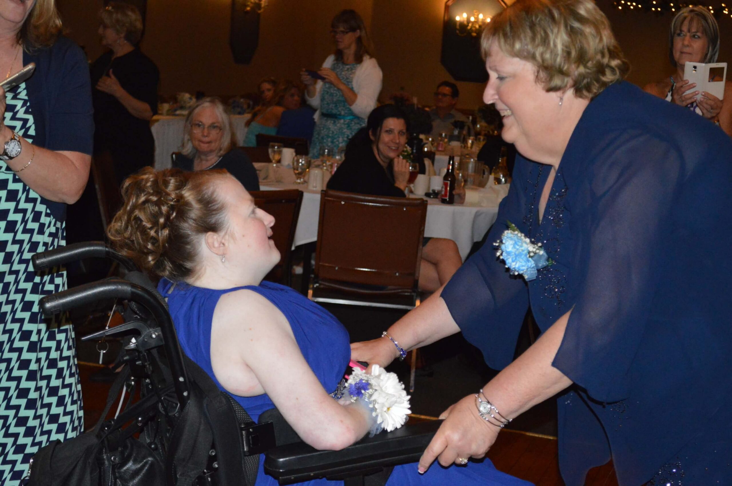 Stacy VanHerreweghe Trisomy 18 Edwards syndrome smiling in her signature pink at a SOFT event