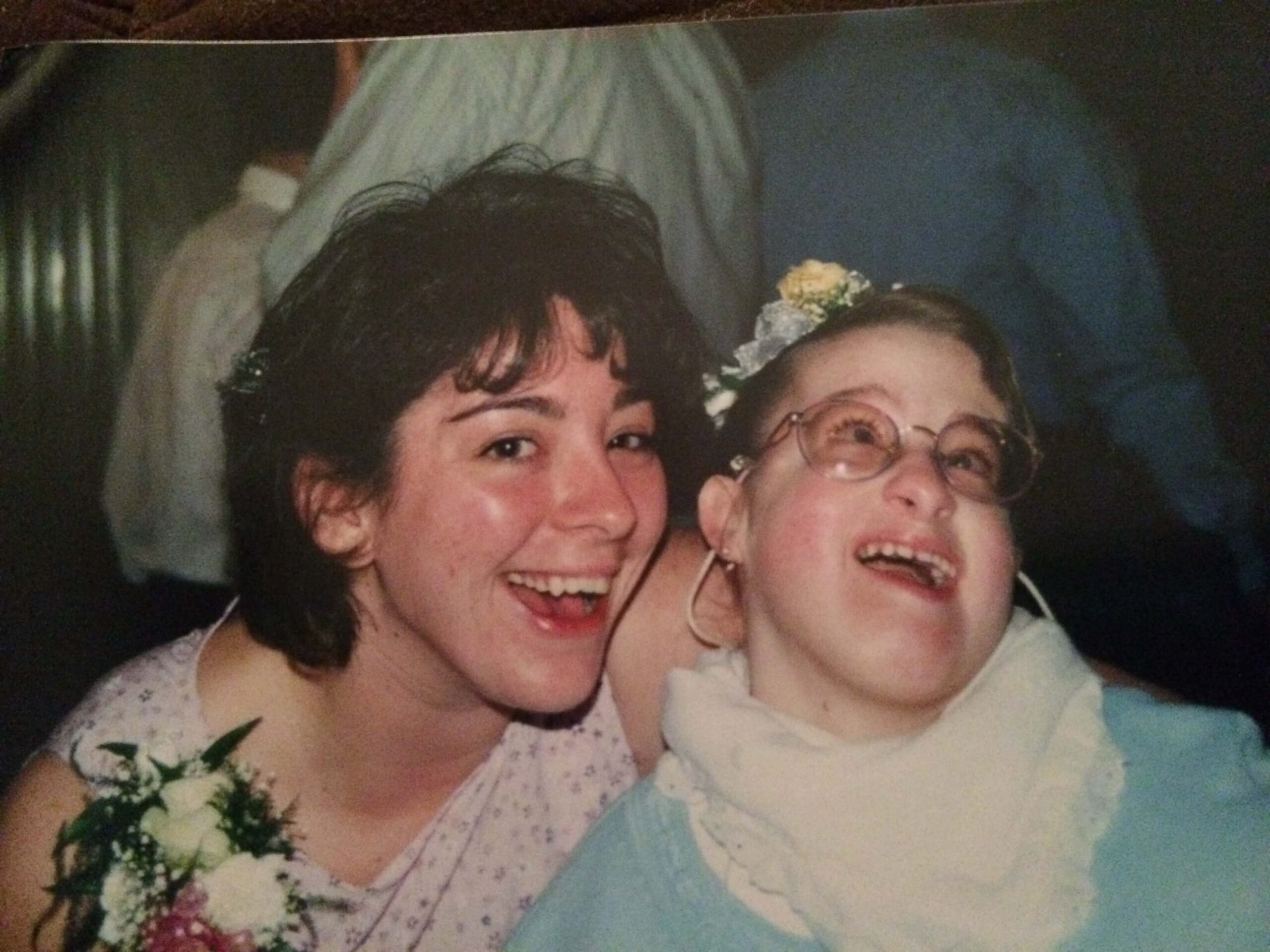 Stacy VanHerreweghe Trisomy 18 Edwards syndrome at school age in pink wheelchair with big smile