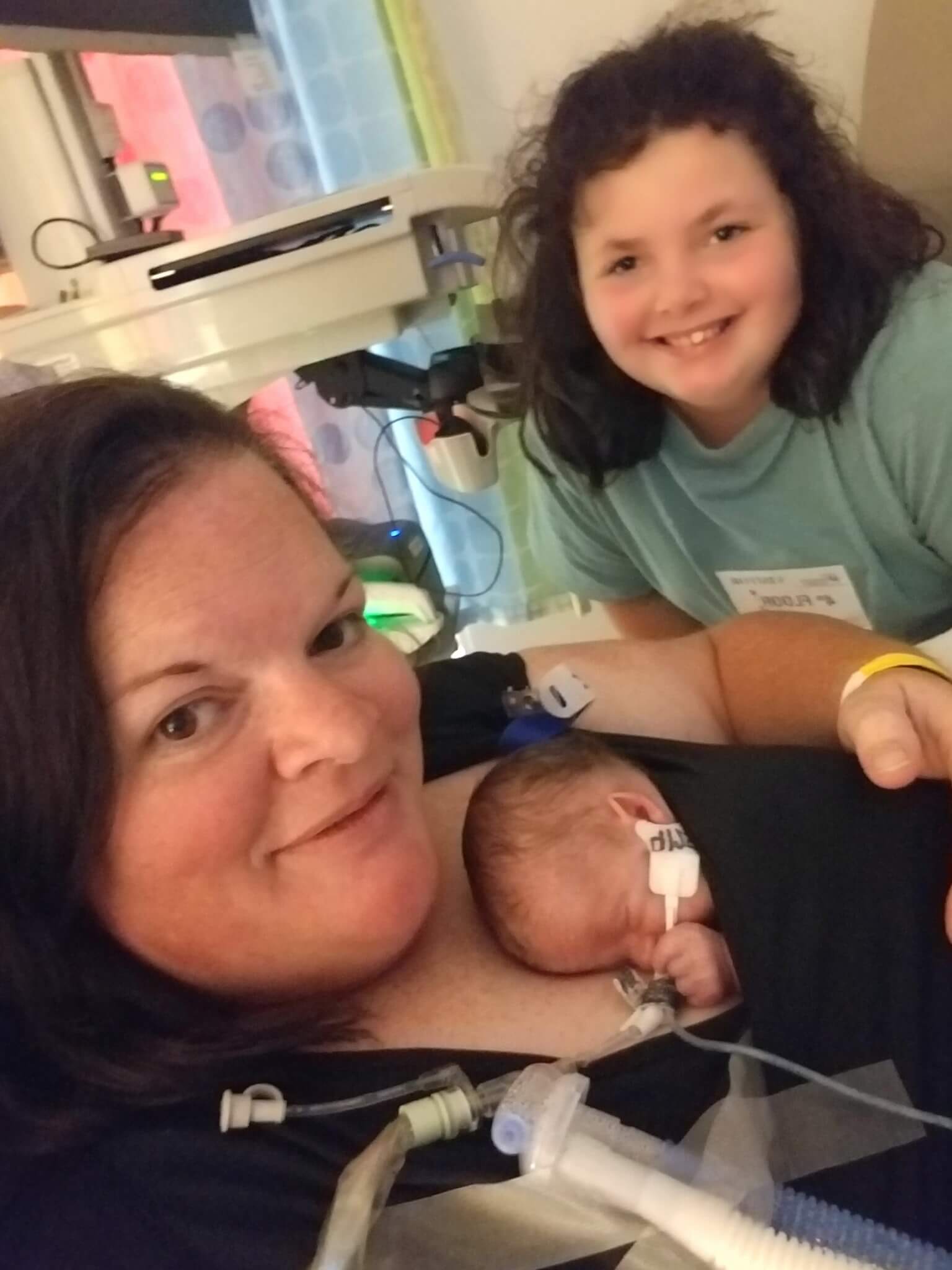 Zoee Wisecarver Trisomy 18 Edwards syndrome being held by her parents Sarah and Darren Wisecarver